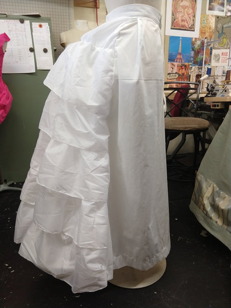 With attached petticoat and back ruffles Victorian cage bustle