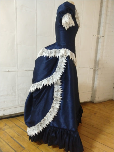 With attached petticoat and back ruffles Victorian cage bustle